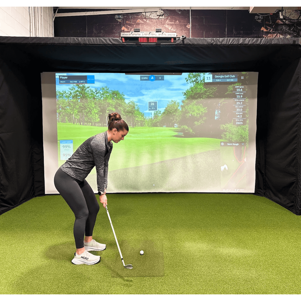Golfie Girl golfing in parlour 16H golf enclosure
