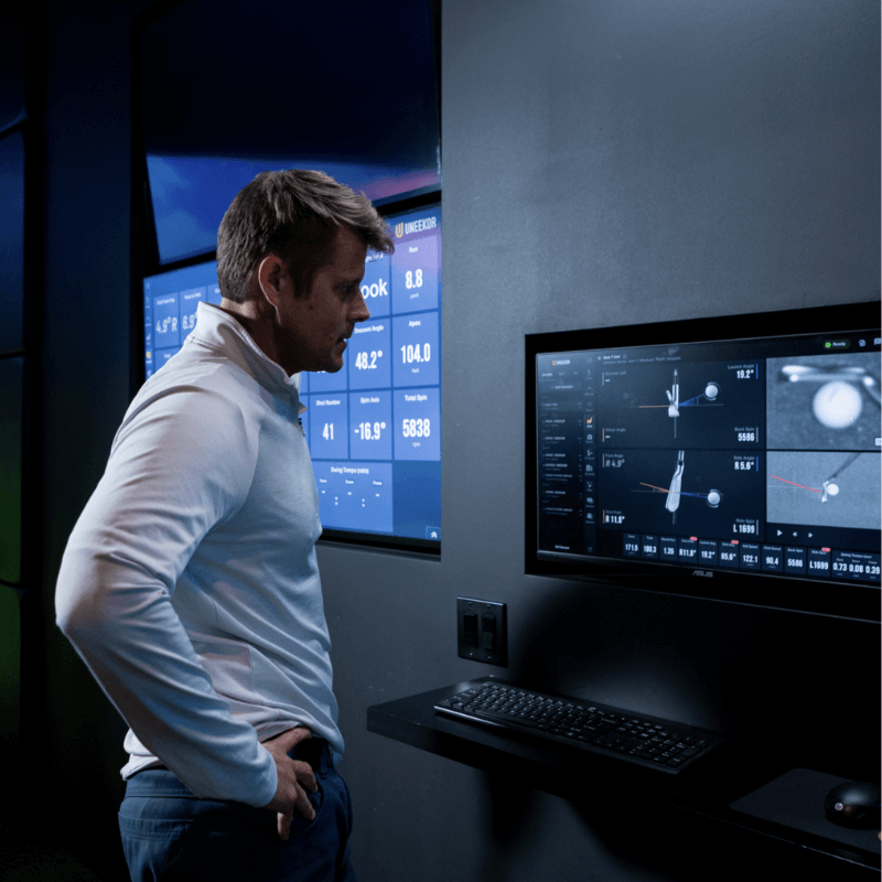 Golfie Uneekor EYE XR Launch Monitor person interacting with shot analysis software